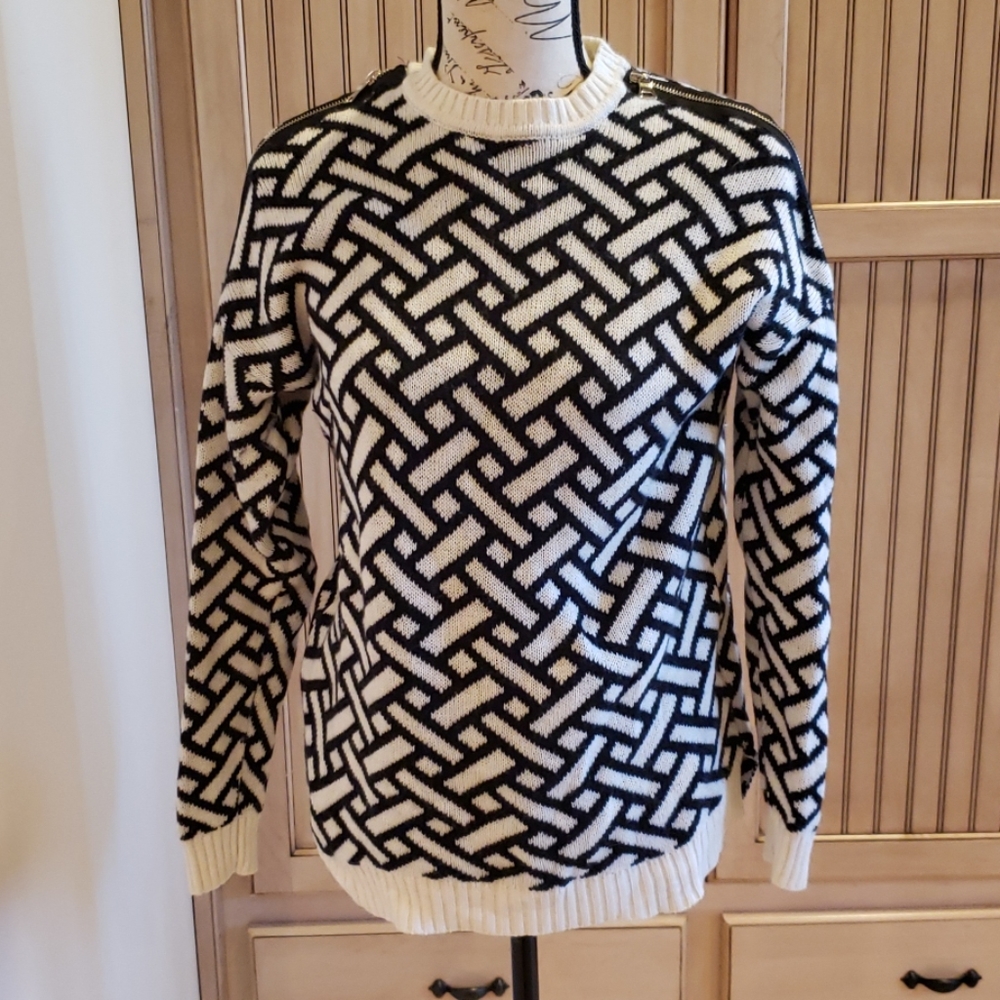 Black and white sweater with zippers on shoulders